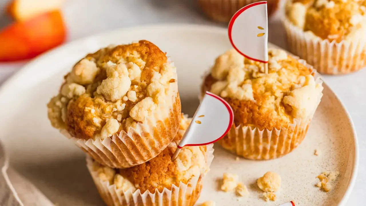 Saftige apfelmuffins mit knusprigen Streuseln, dekoriert mit süßen Apfel-Fähnchen. Ein Genuss für jeden Apfelliebhaber!