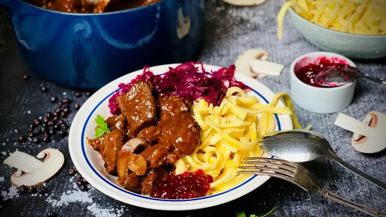 Herzhaftes Rehgulasch mit Spätzle, Rotkohl und Preiselbeeren. Ein köstliches Rehgulasch Rezept für Genießer.