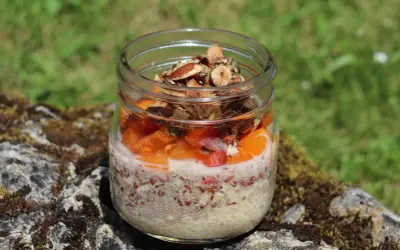 Veganes Overnight Oats im Glas mit Früchten und Nüssen, perfekt für einen gesunden Start in den Tag.