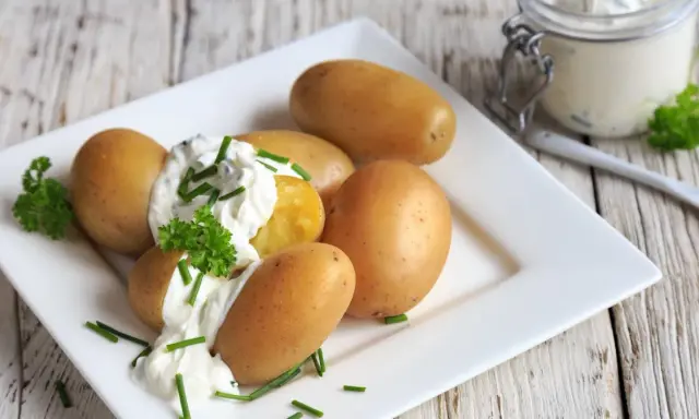 Kleine, goldbraune Kartoffeln mit cremigem Quark und frischem Schnittlauch garniert. Ein Klassiker: Kartoffeln mit Quark.